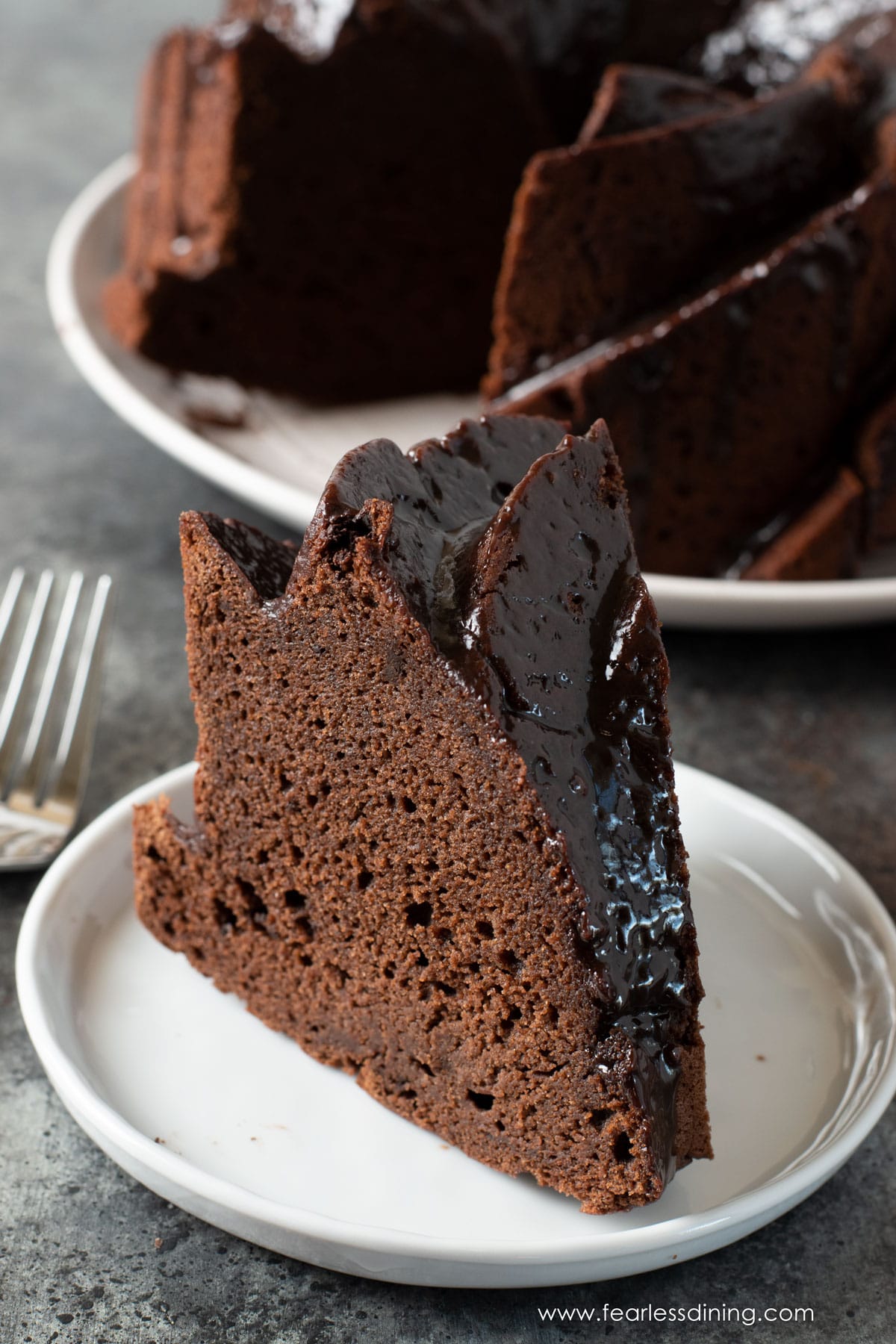 a slice of chocolate bundt cake on a plate.