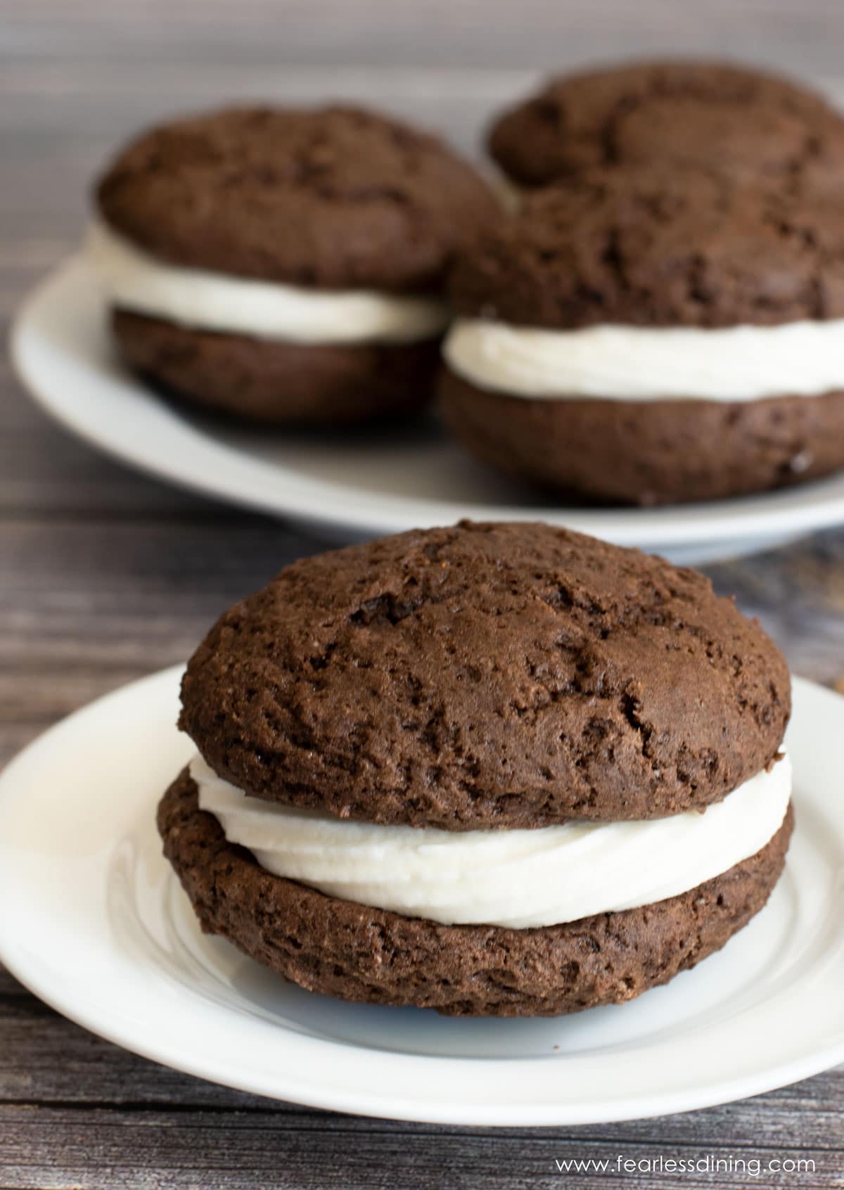 A whoopie pie on a small white plate.