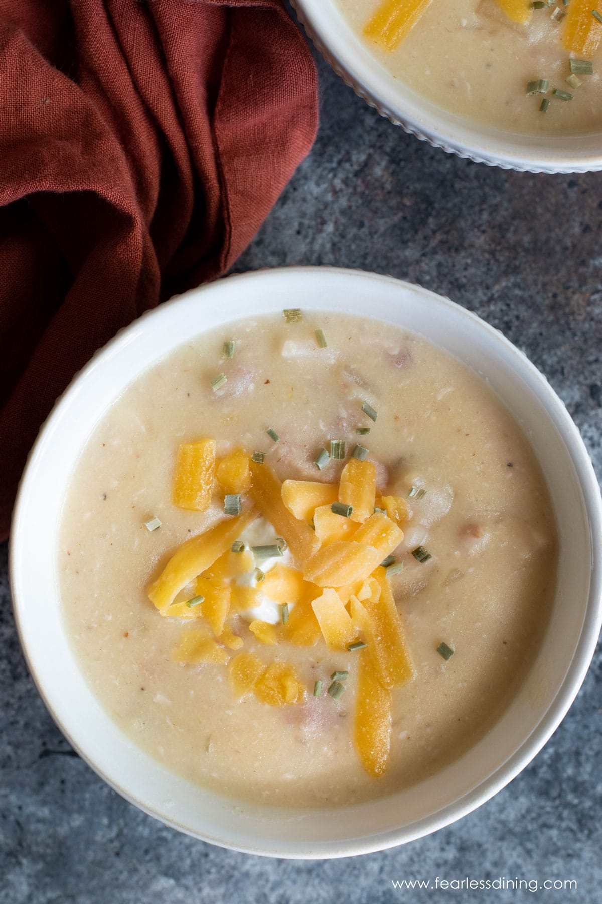 The top view of a bowl of chicken potato soup.