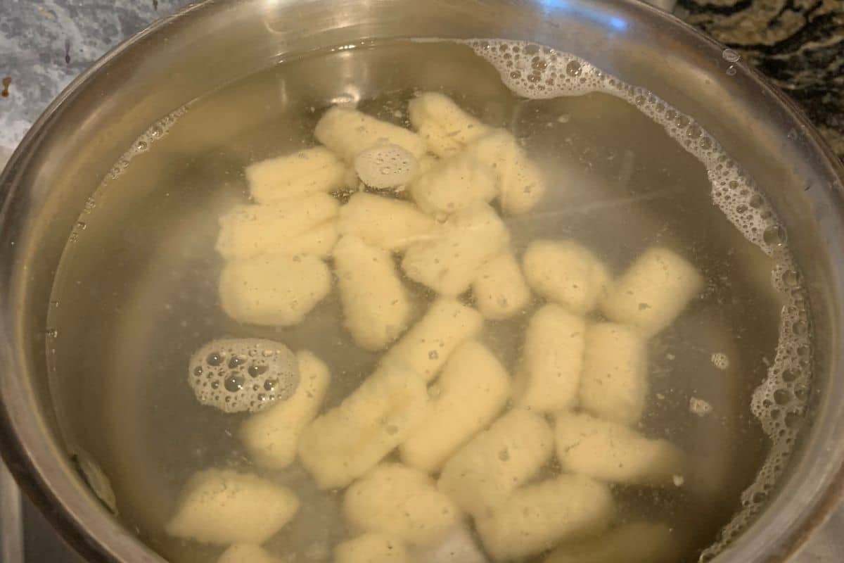 Adding gnocchi to boiling water.