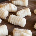 A Pinterest image of gluten free gnocchi ready to cook.