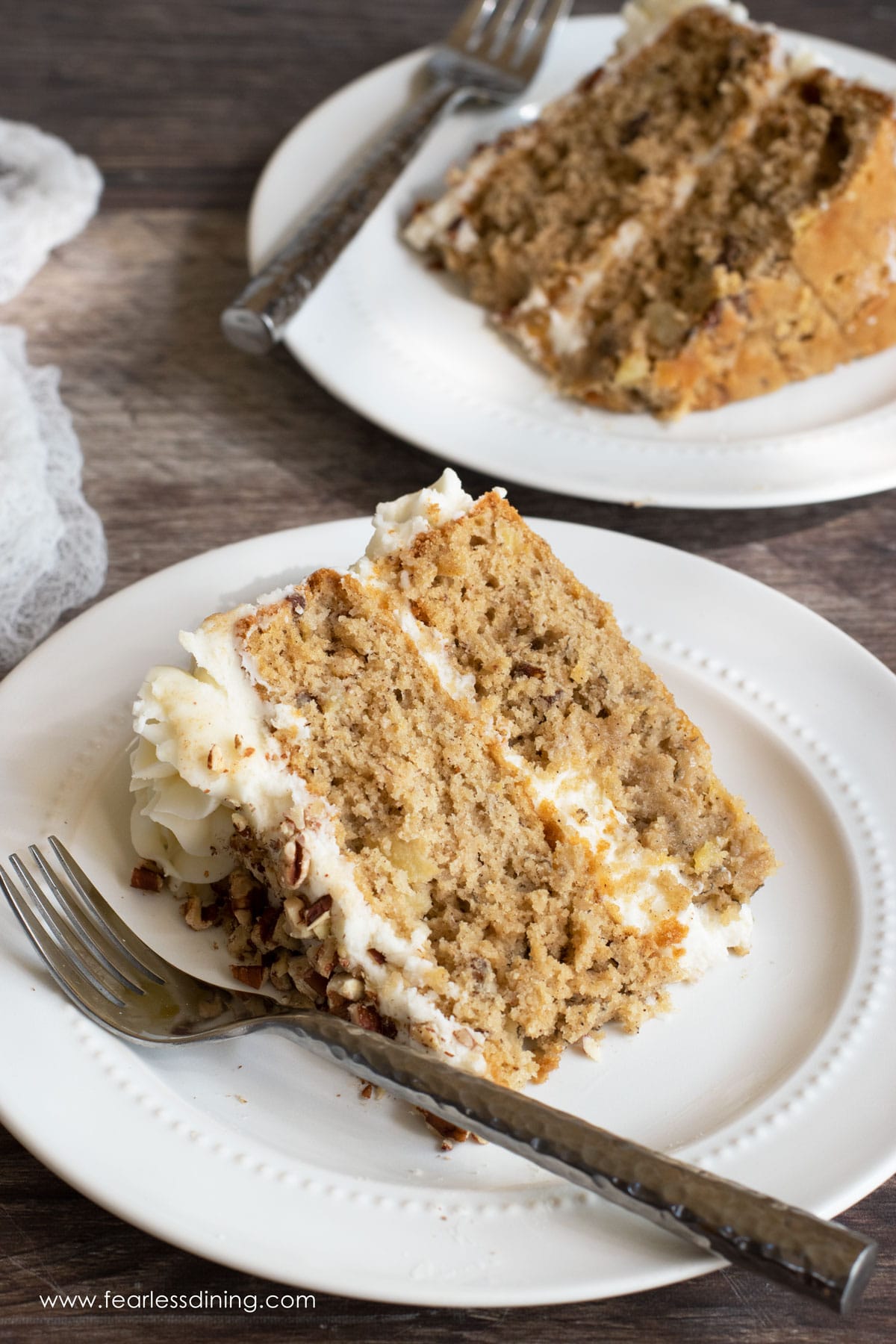 Two slices of hummingbird cake on small plates.