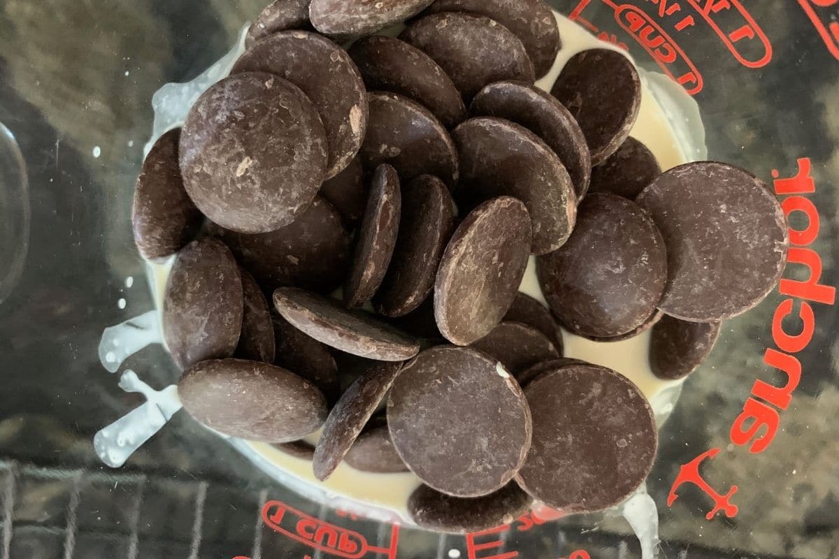 The melting chocolate wafers in heavy cream.