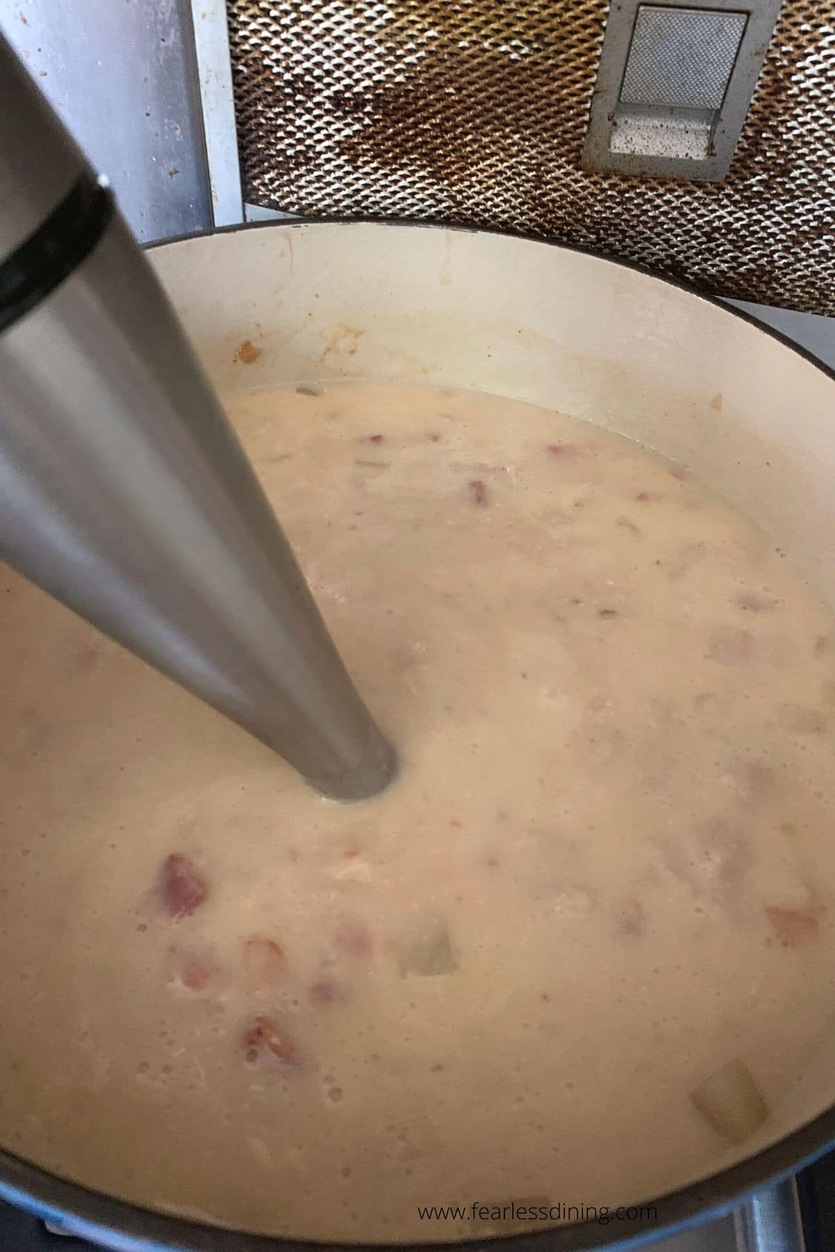 Using an immersion blender in the soup.