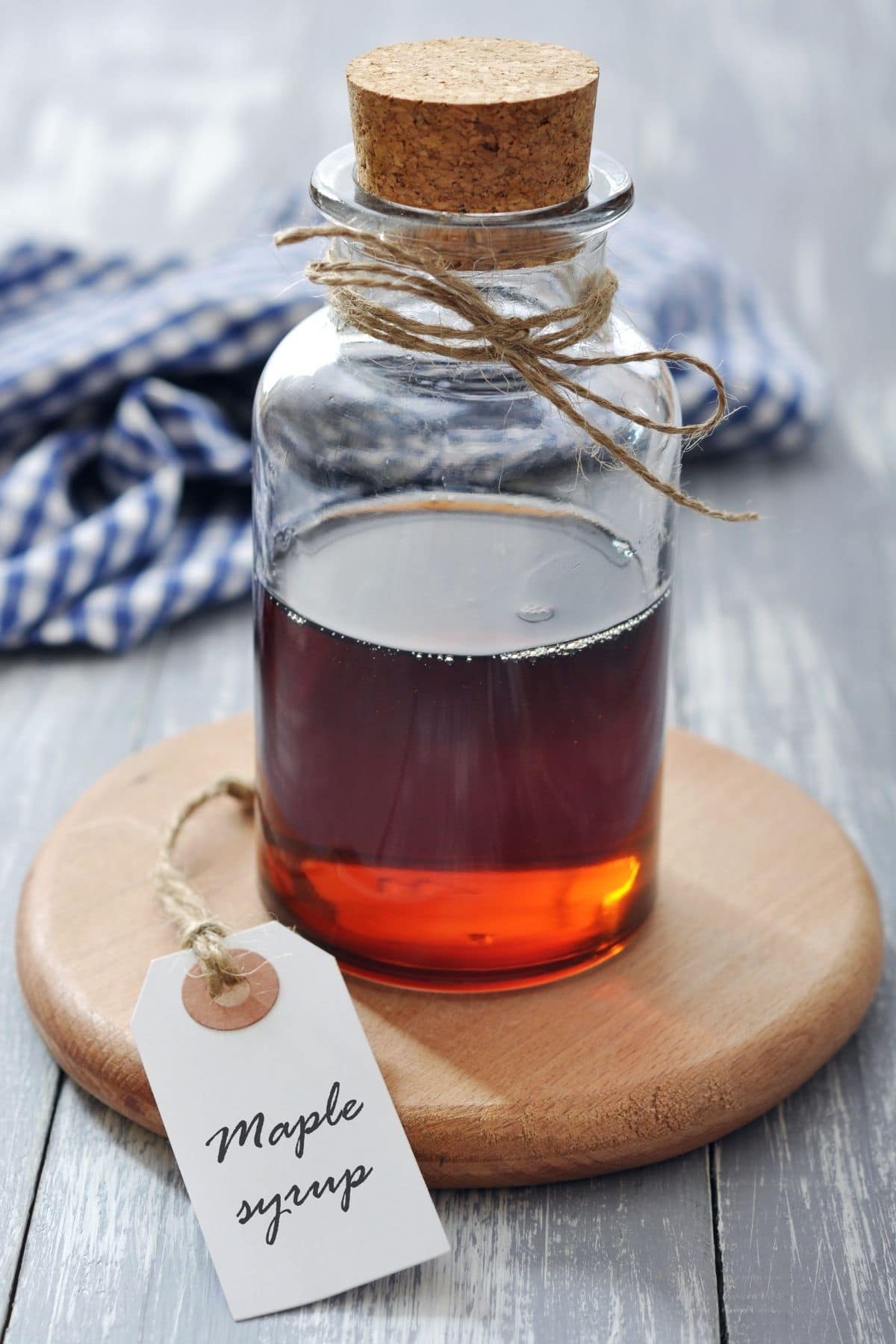 A glass jar filled with pure maple syrup.