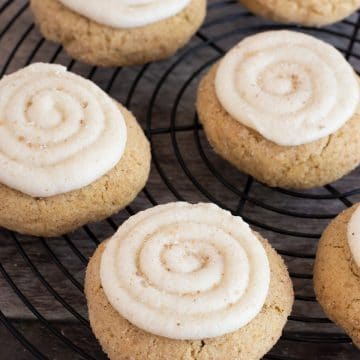 A rack of cinnamon sugar frosted gluten free crumbl cookies.