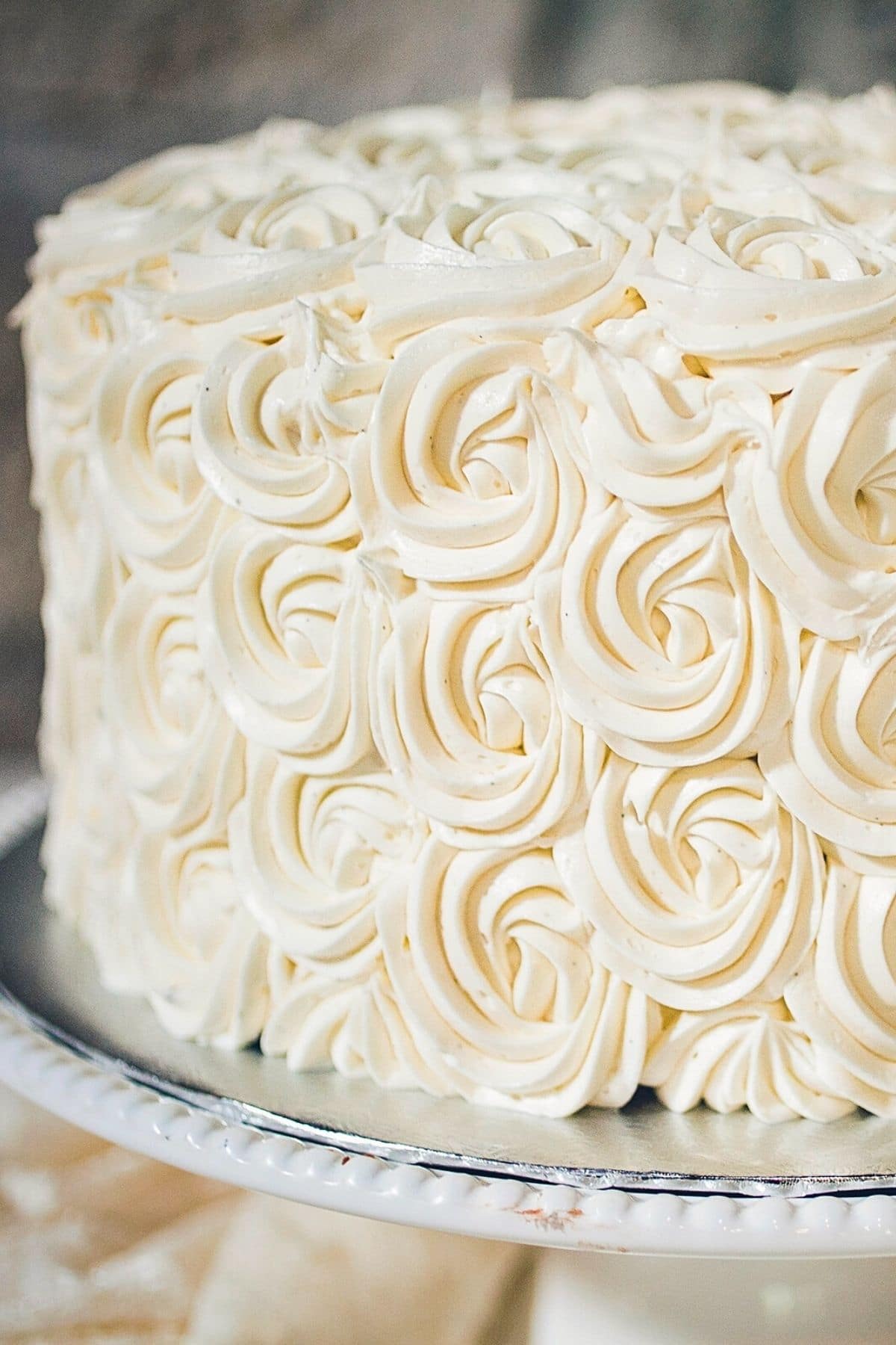 A close up of swirled frosting used to cover and decorate a cake.