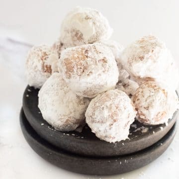 A bowl of powdered sugar donut holes.