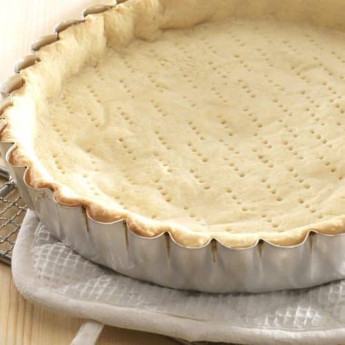 A photo of my gluten free pie crust blind baked in a pie tin.