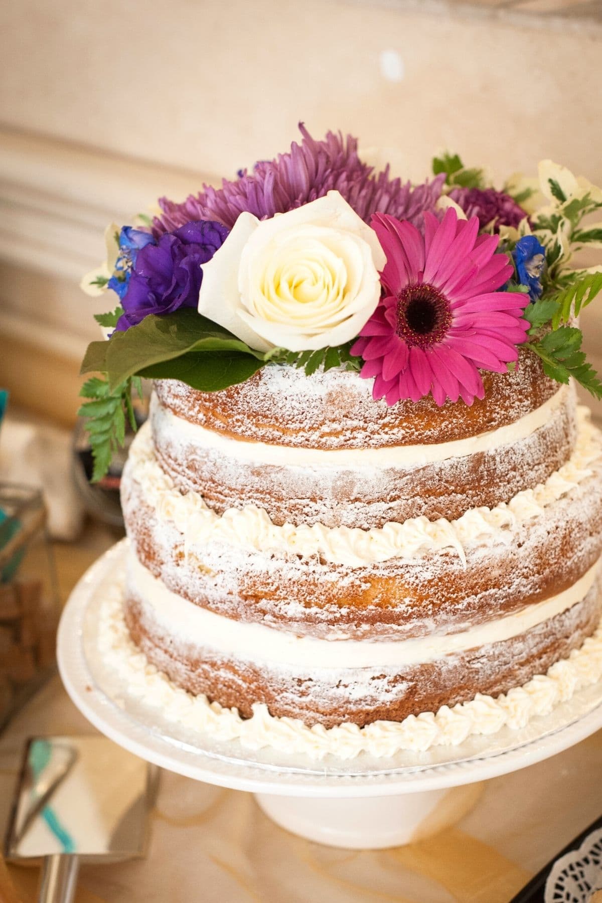 A photo of a naked three tiered cake.