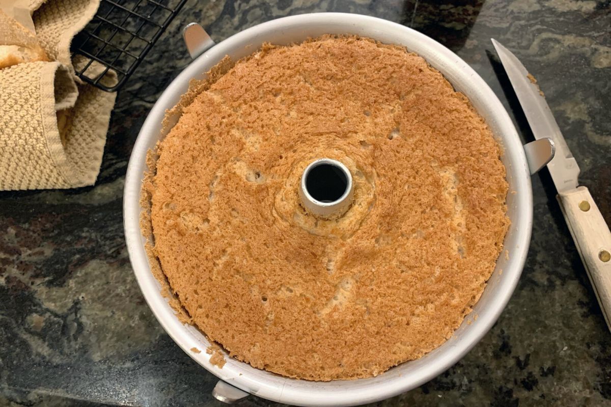 A baked angel food cake in the pan.