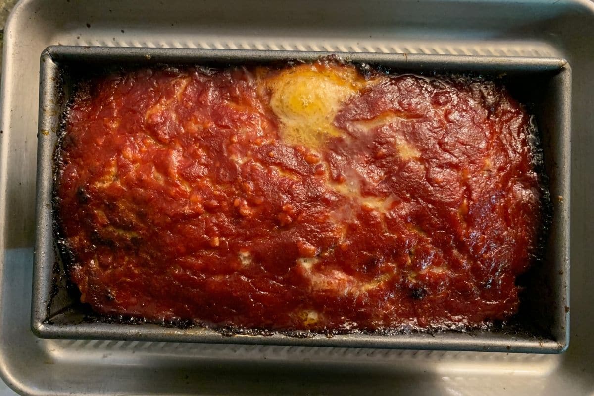 A baked meatloaf in a loaf pan.