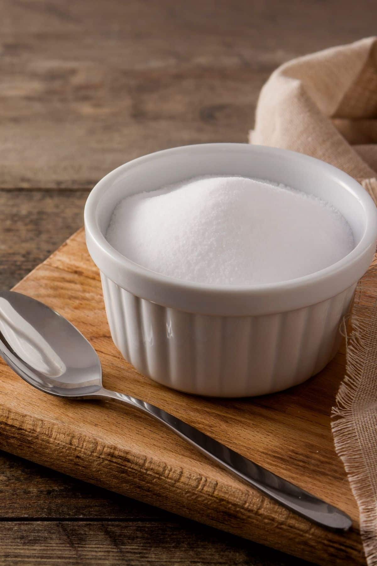 A white ramekin with cream of tartar powder.