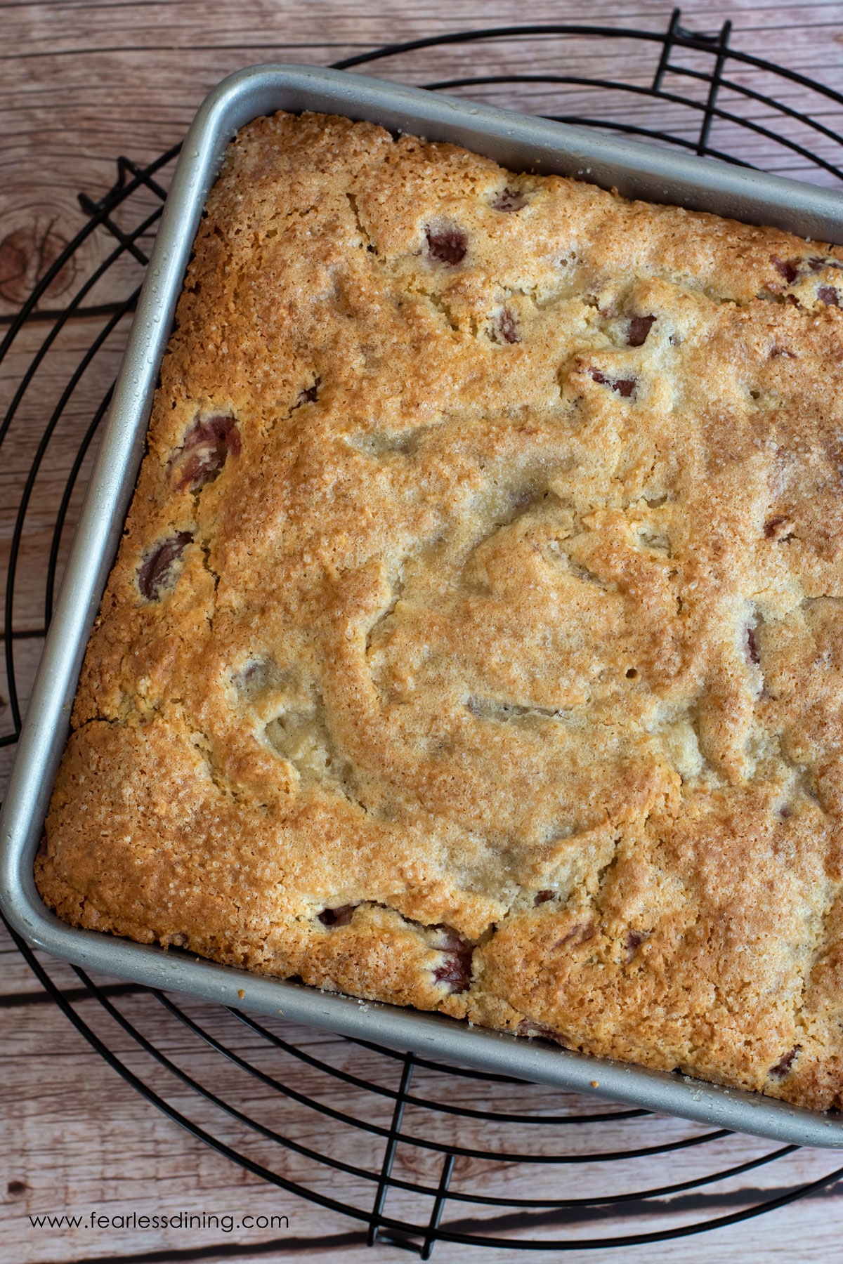 A baked gluten free cherry cake in an 8x8 pan.