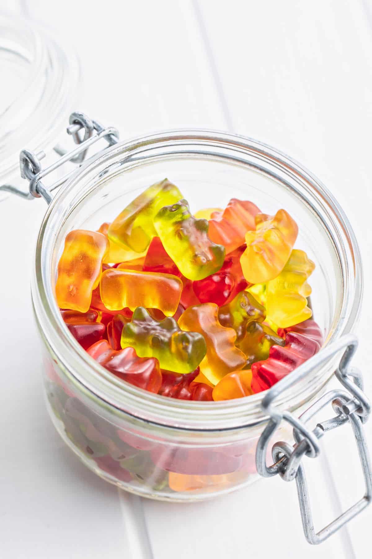 a glass jar full of gummy bears.