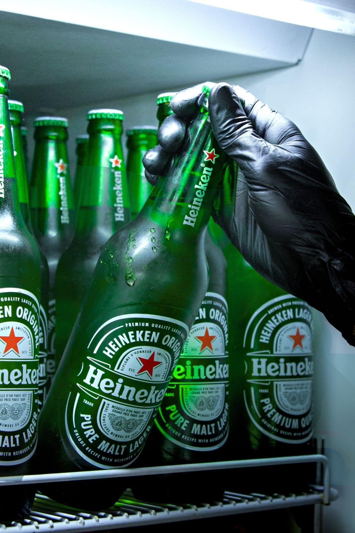 Taking a Heineken beer out of the refrigerator.