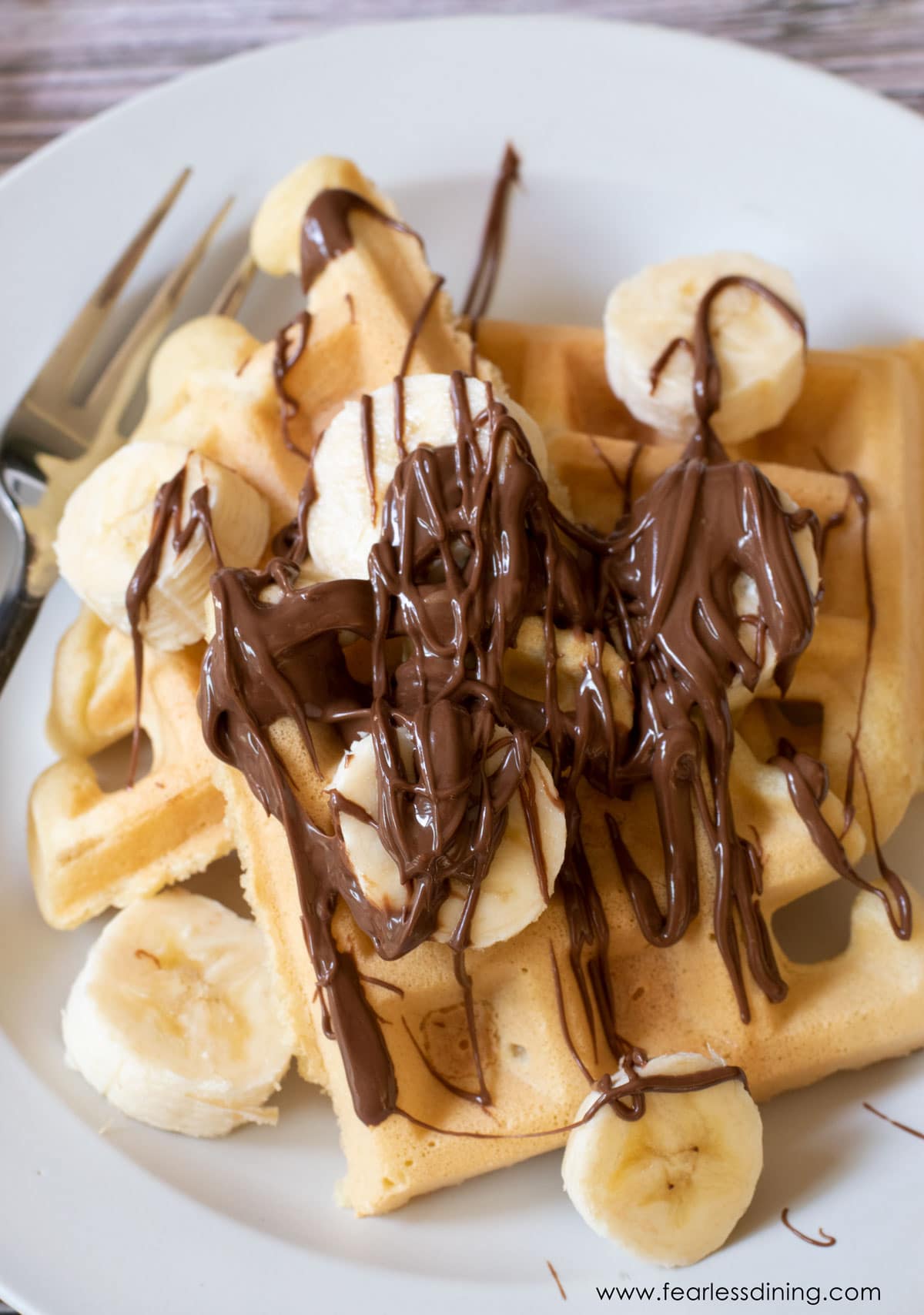 Mochi waffles topped with sliced bananas and Nutella.