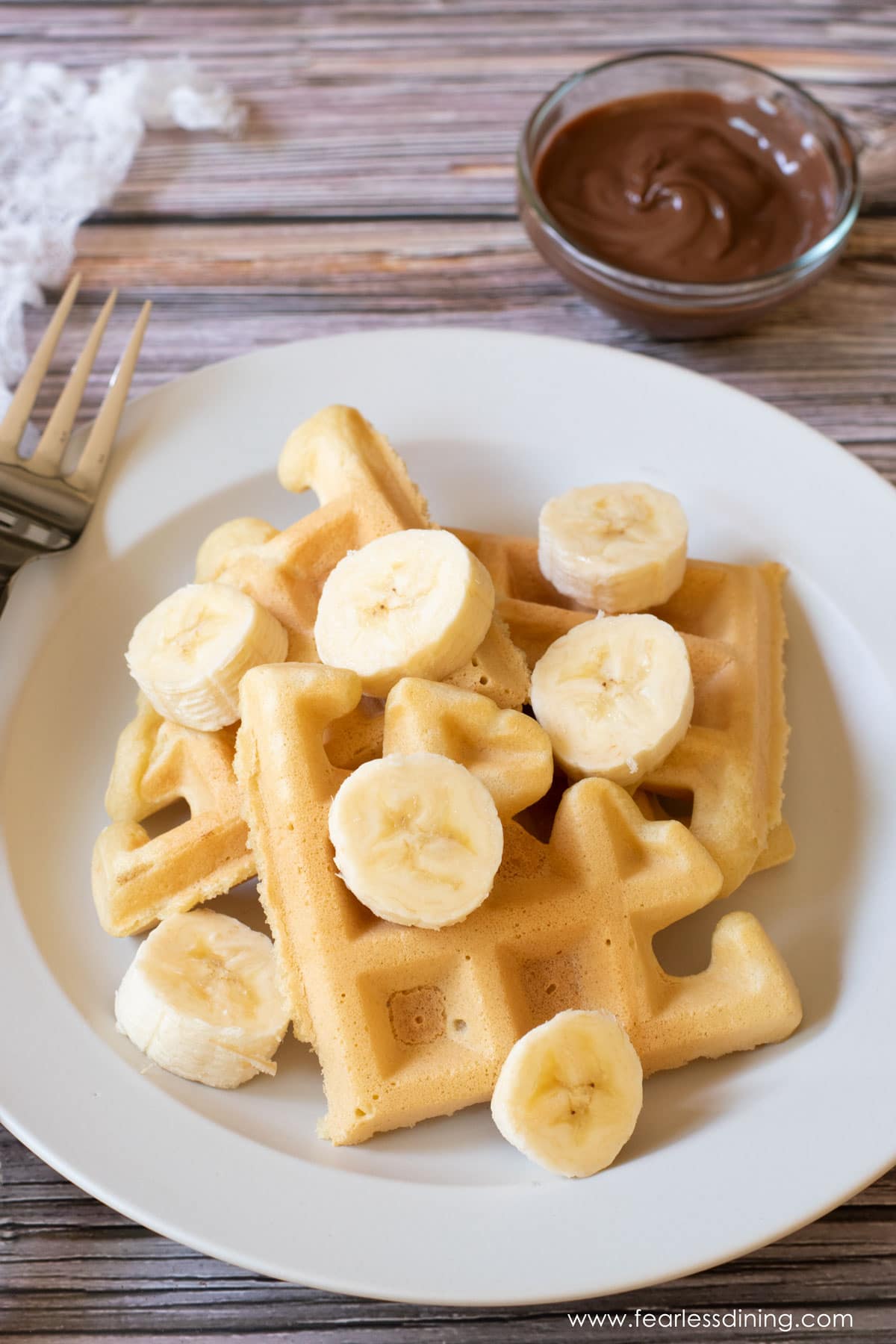 Mochi waffles topped with sliced bananas.
