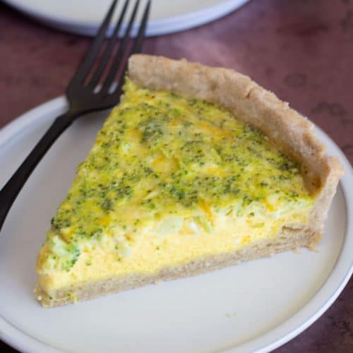 A slice of gluten-free quiche loaded with cheddar and broccoli.