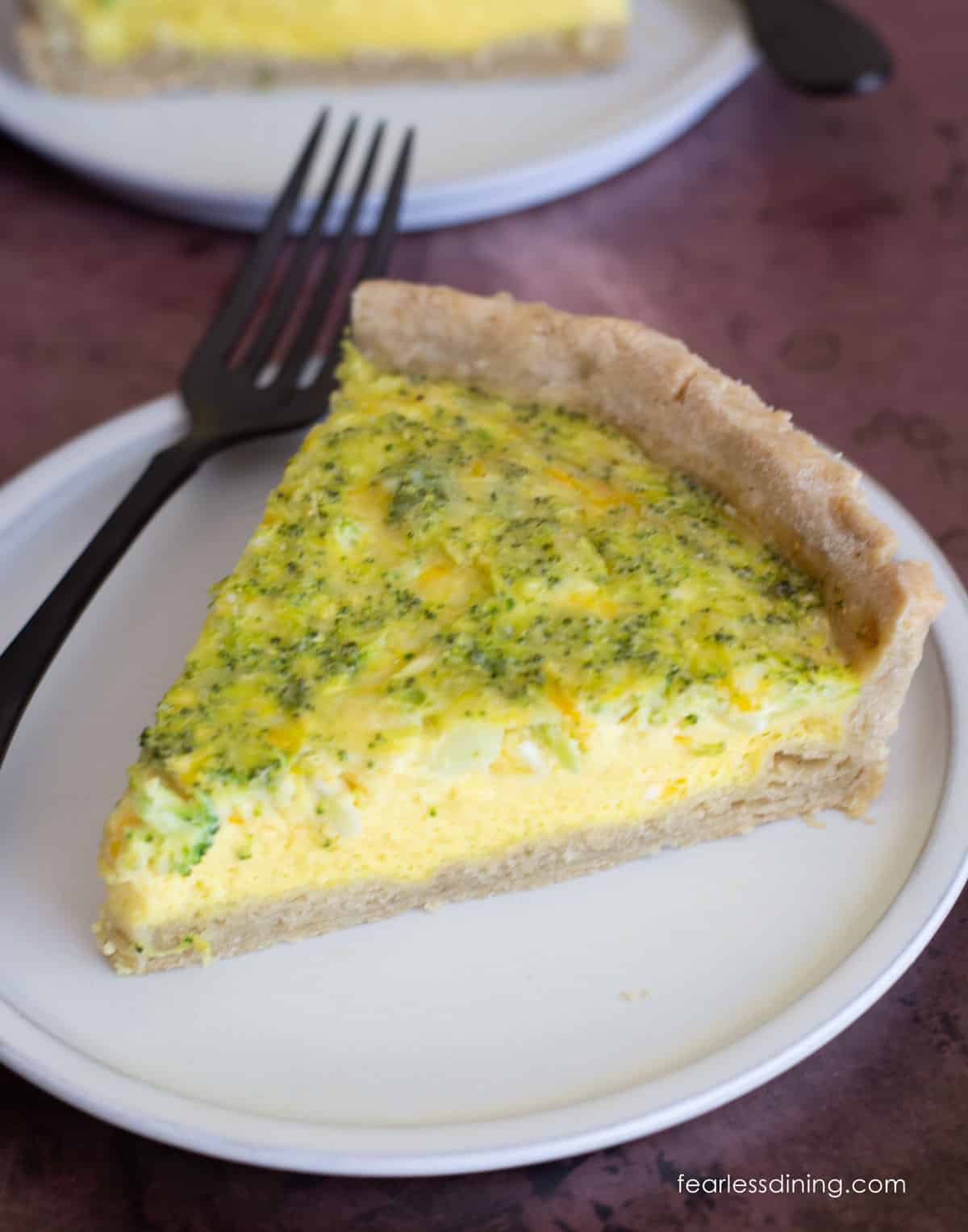 A slice of gluten-free quiche loaded with cheddar and broccoli.