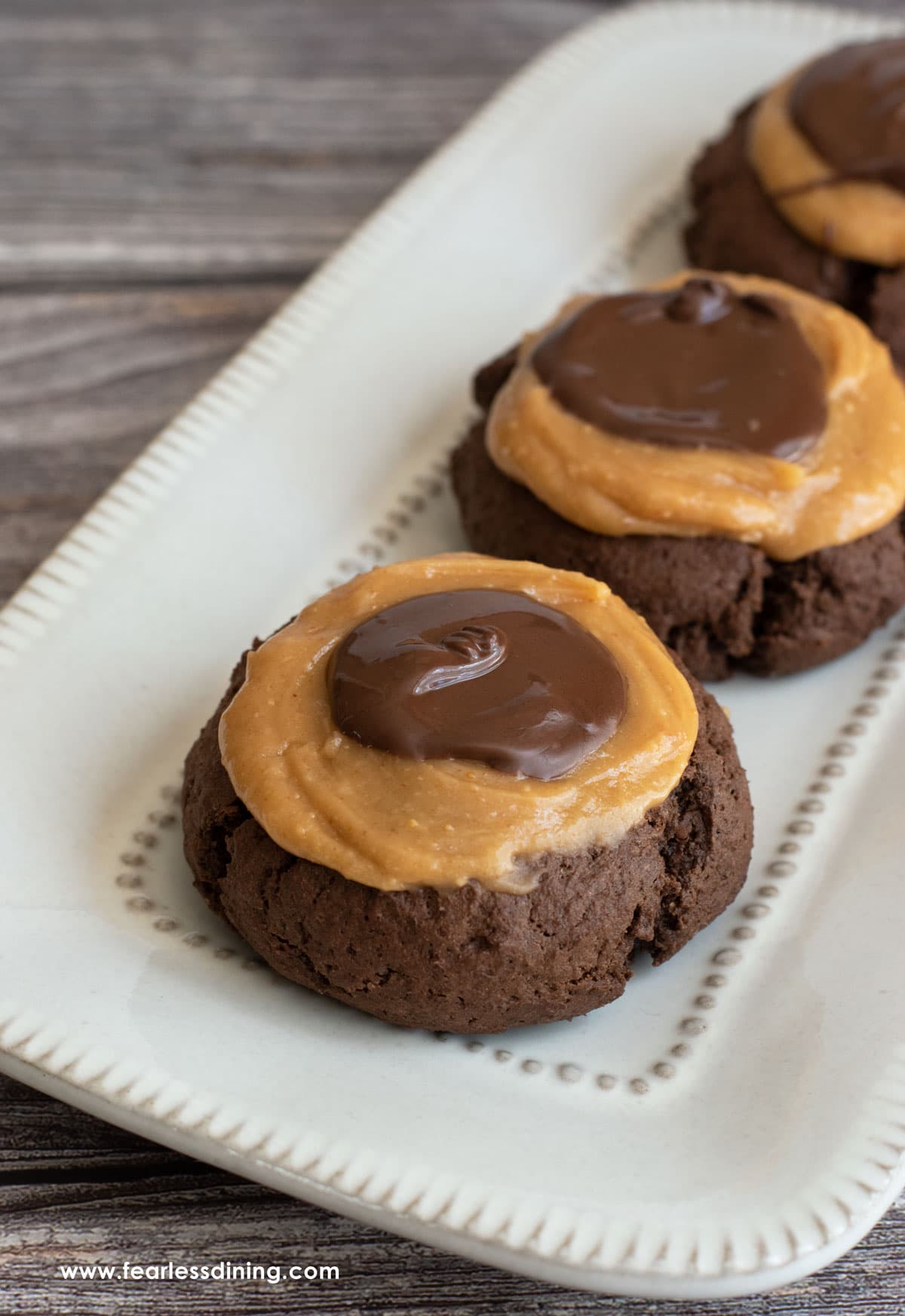 A row of gluten free buckeye cookies on a plate.