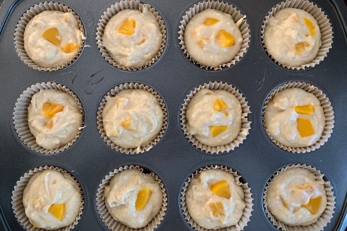 The cupcake pan filled with cupcake batter.