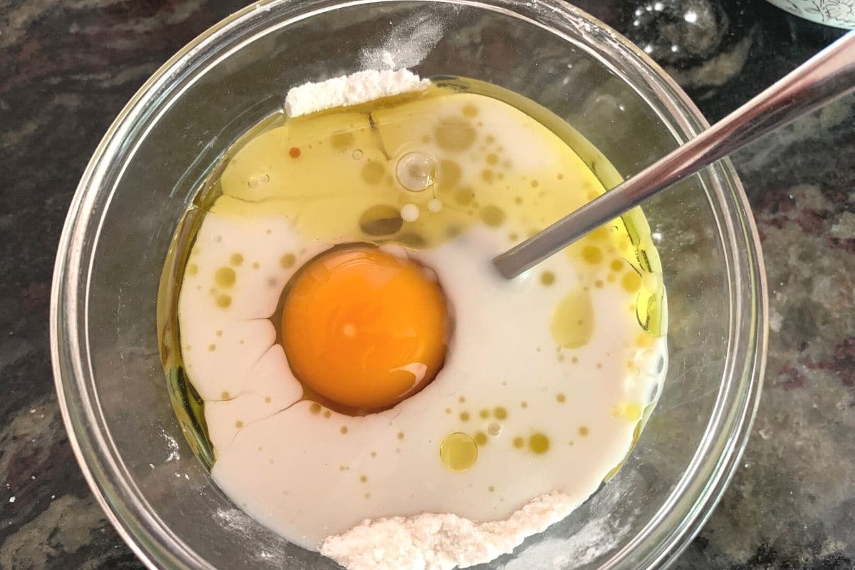 A small bowl filled with the cone cupcake wet ingredients.