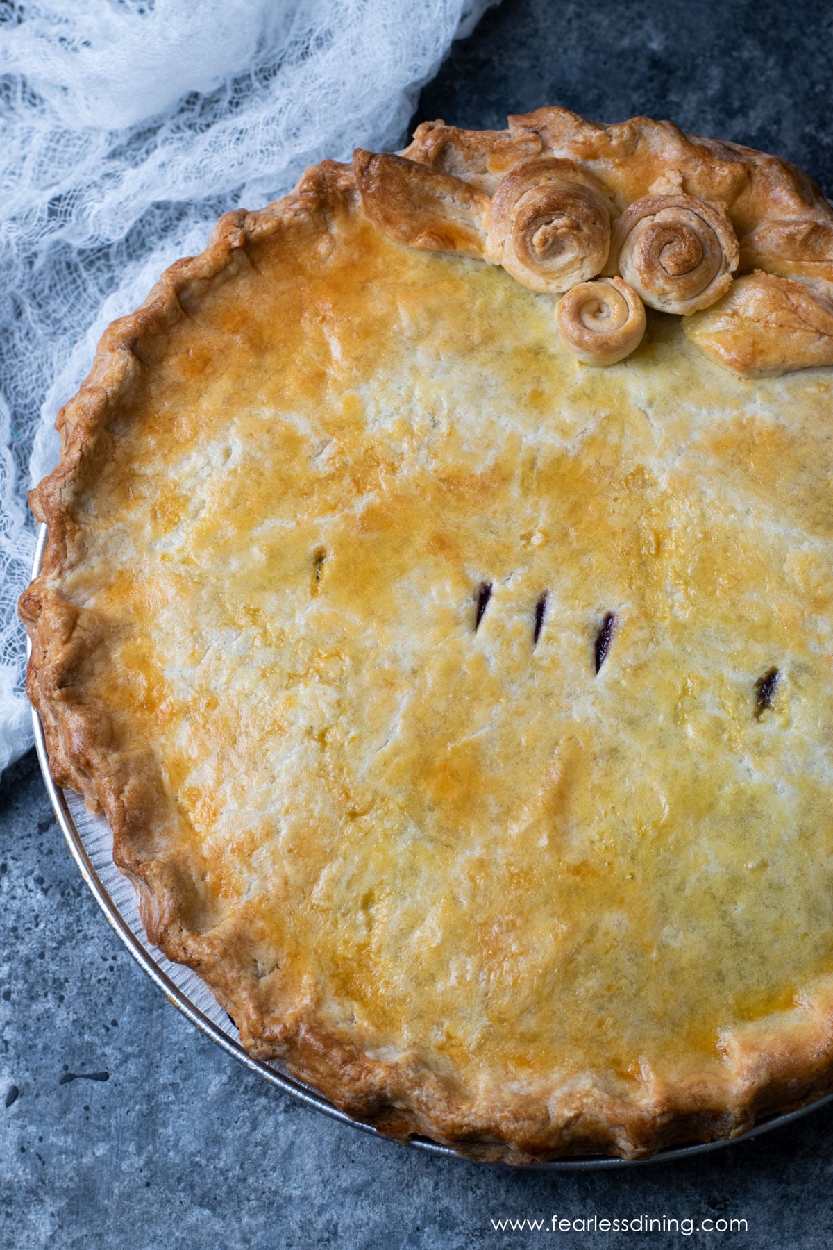 A photo of the top of the baked gluten free blueberry pie.