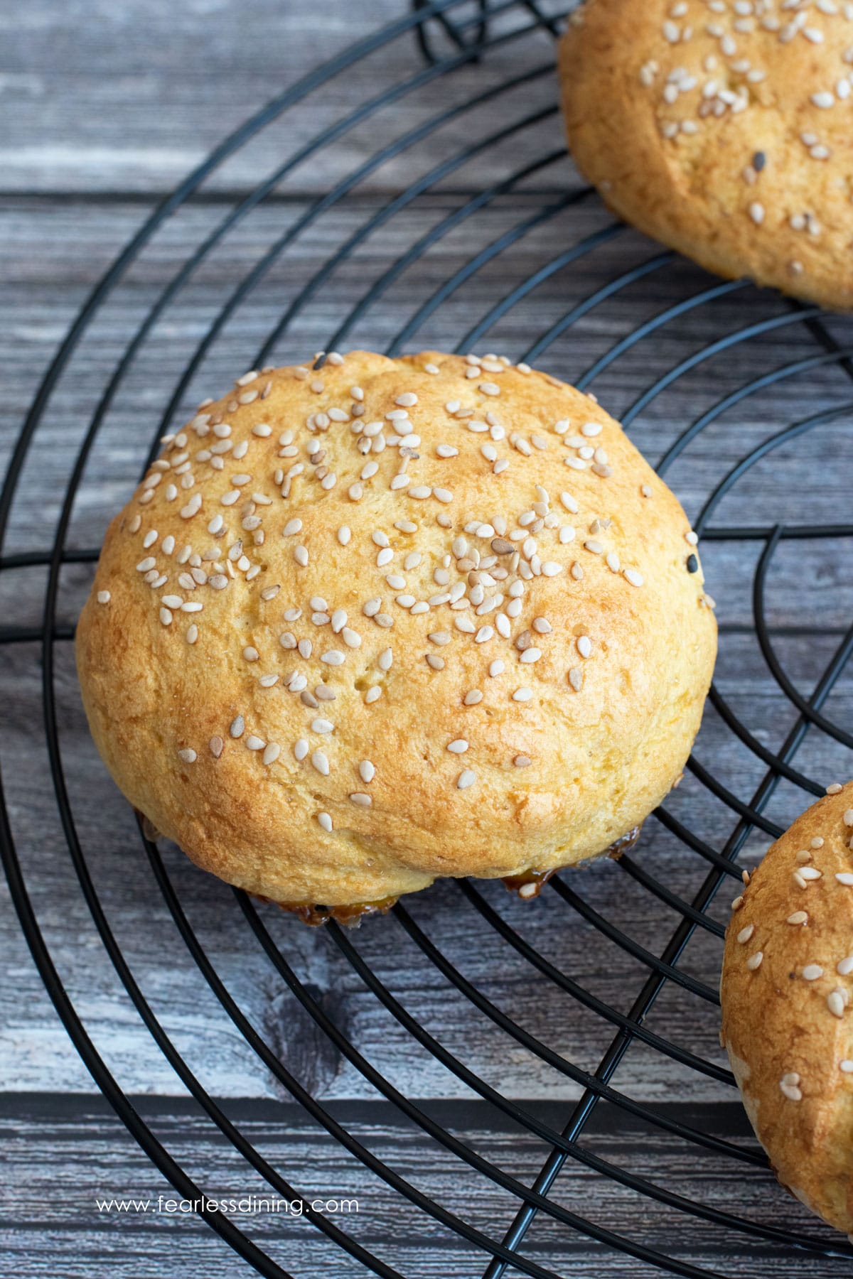 Gluten free hamburger buns cooling on a wire rack.