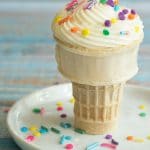 A gluten free cupcake cooked in a mug on a plate.