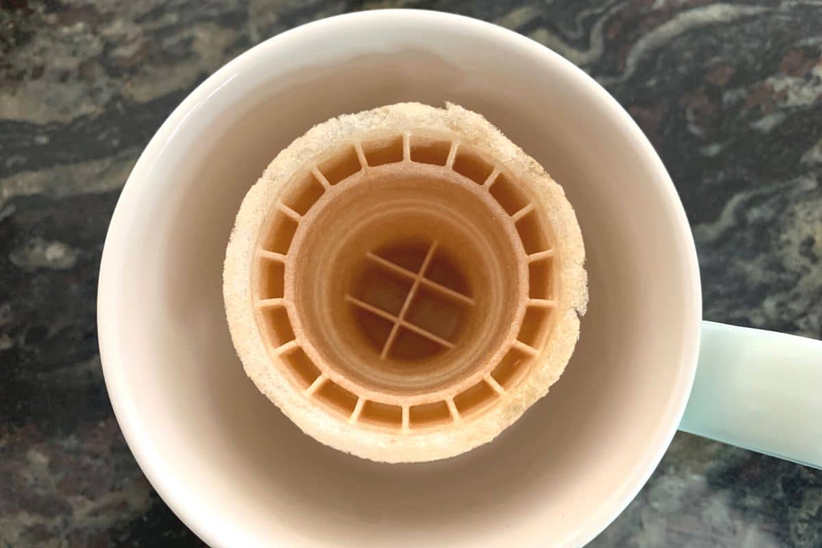an empty ice cream cone in a mug.