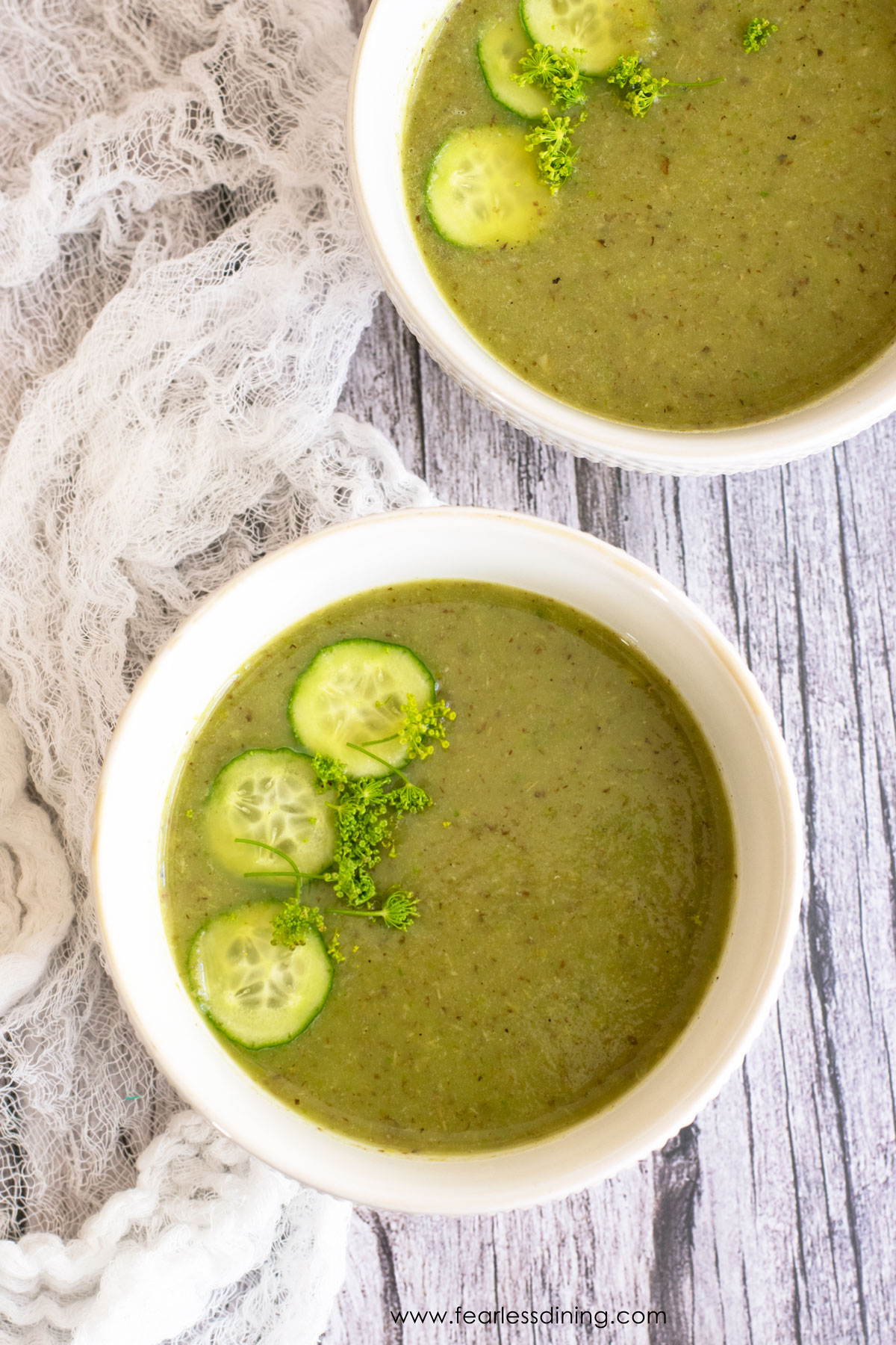 The top view of two bowls of chilled shishito peppers soup.