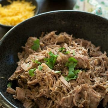 A big black bowl full of gluten free pulled pork.