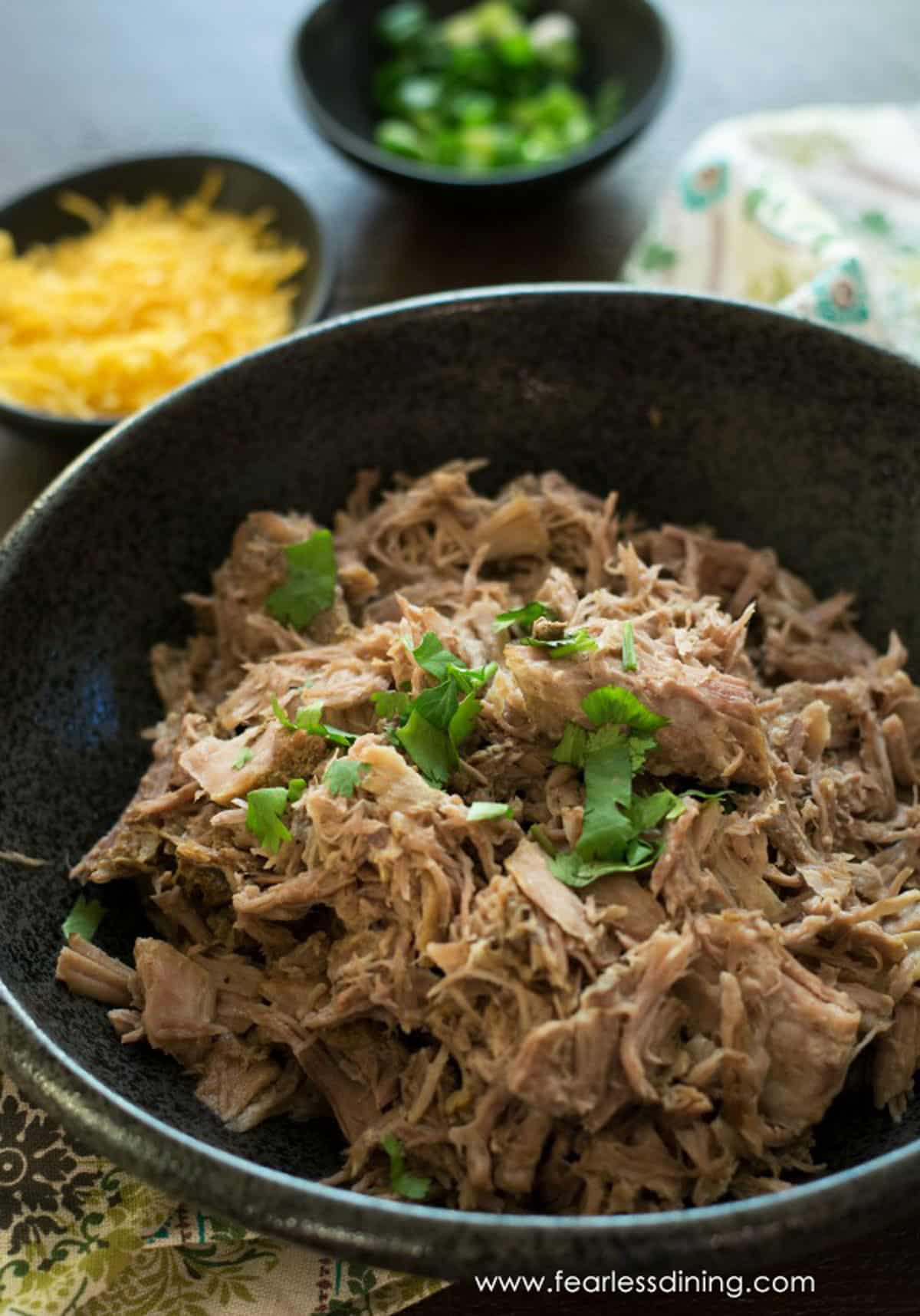 A big black bowl full of gluten free pulled pork.