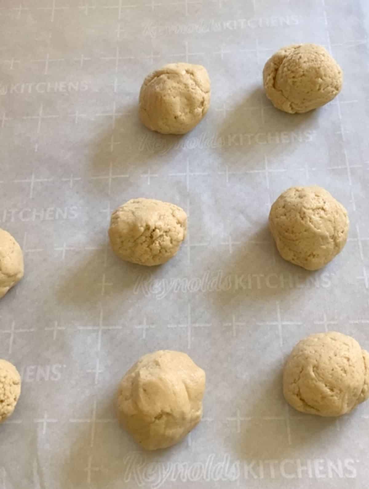 cornbread cookie dough balls on a baking sheet.
