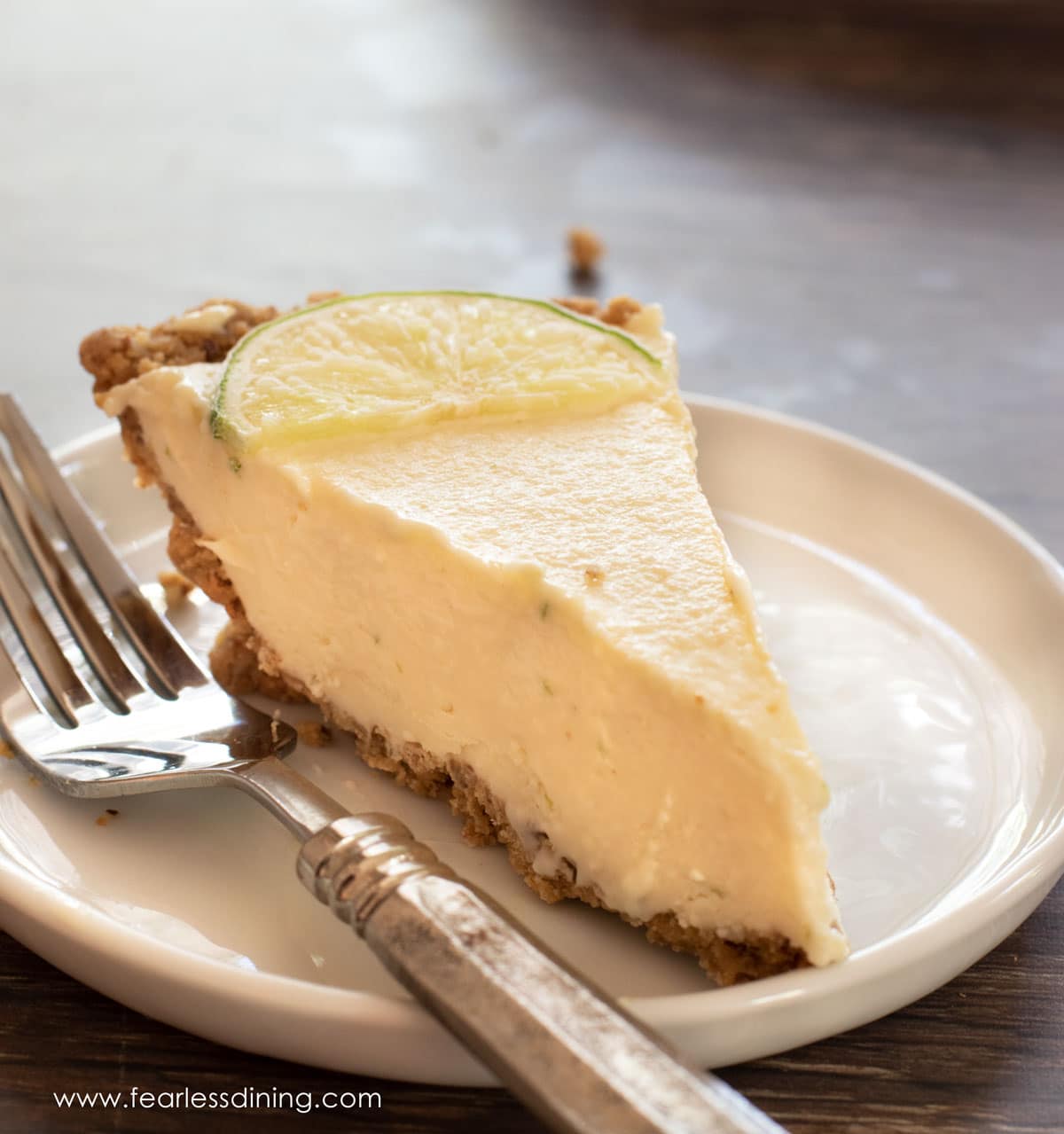 A slice of gluten free key lime pie on a plate.