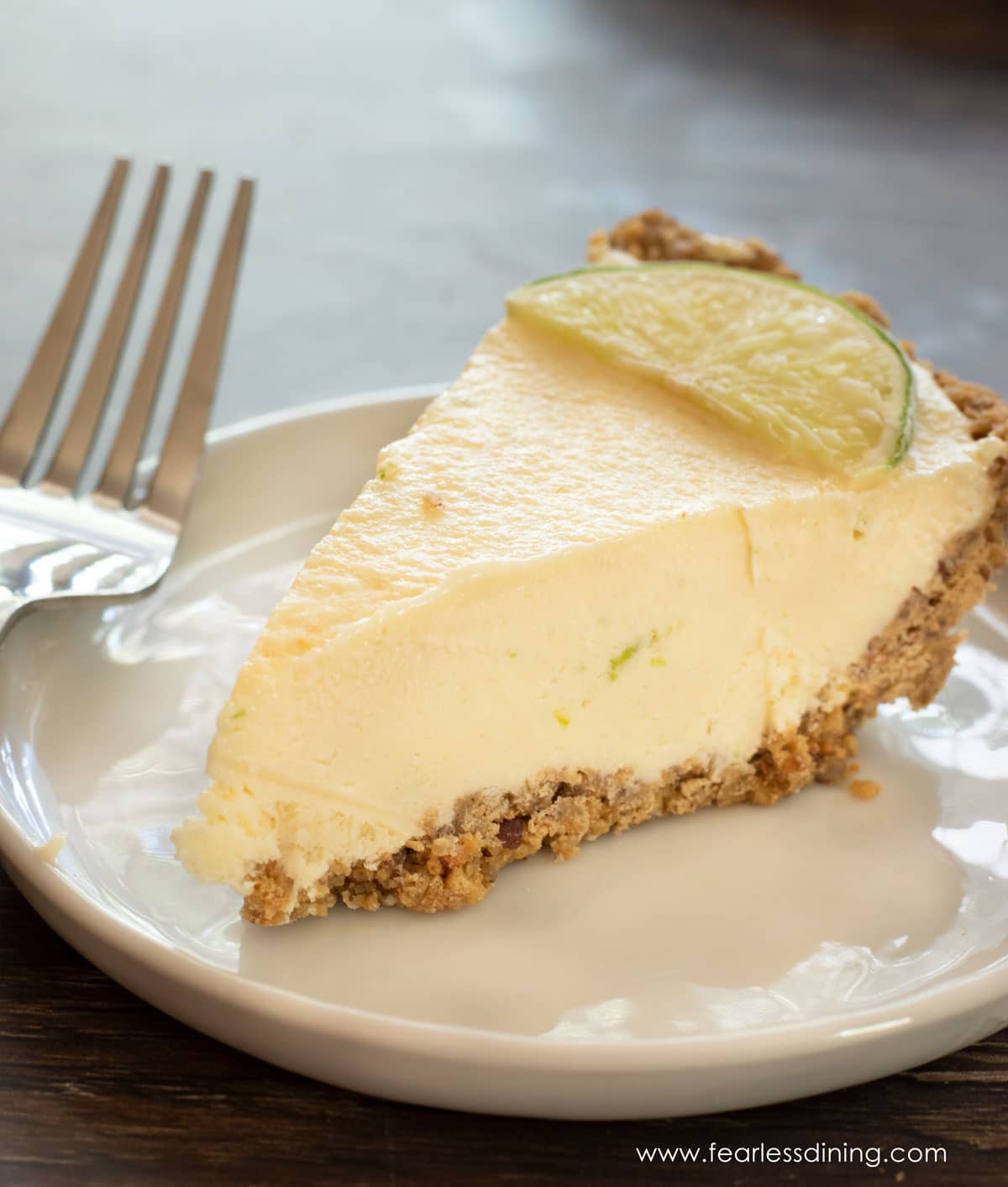 A close up photo of a slice of the key lime pie.