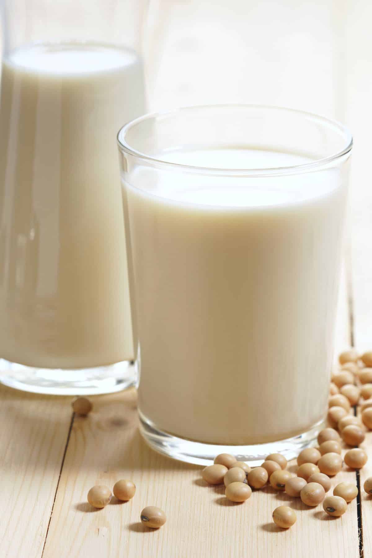 a glass of soy milk on a table.