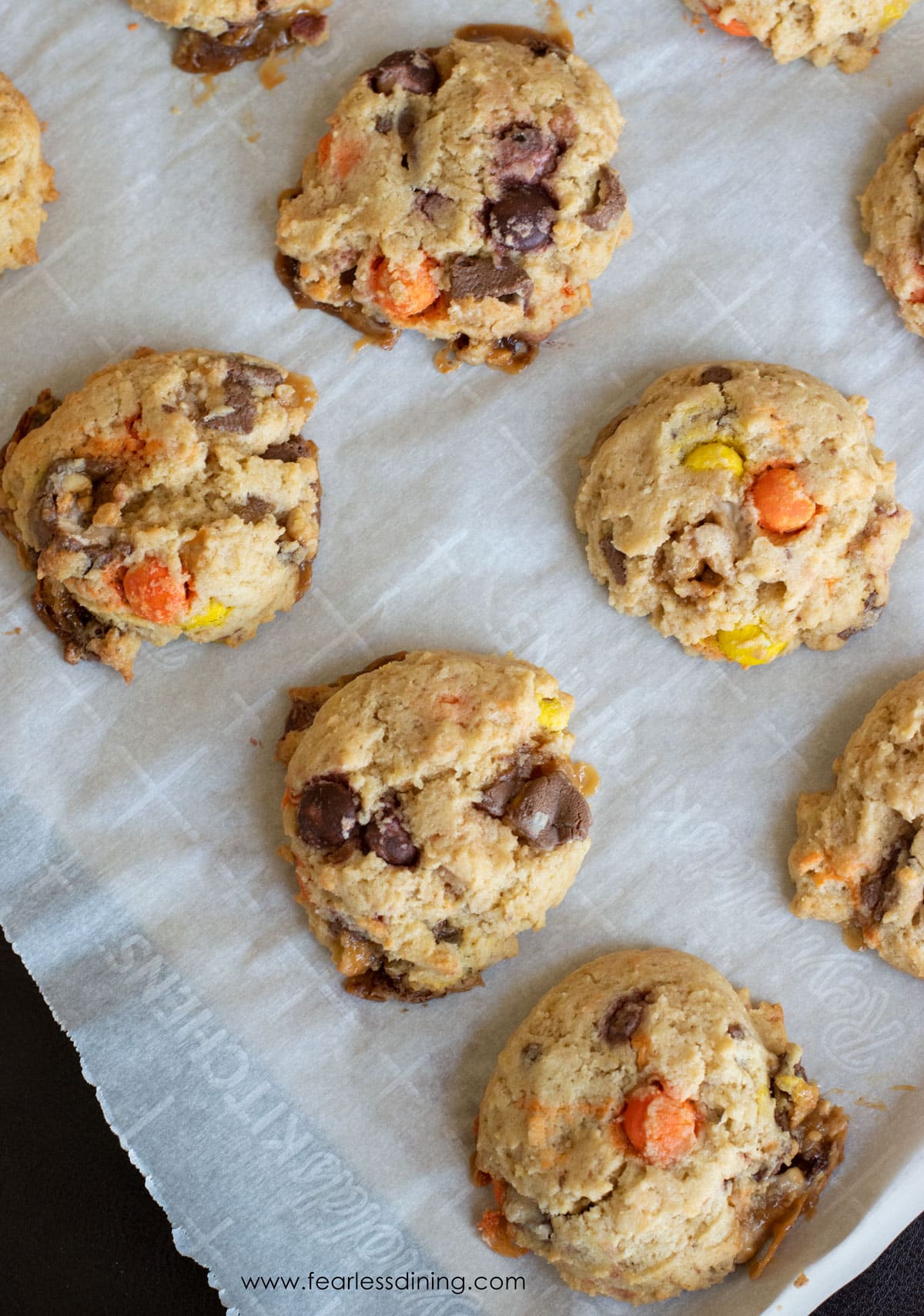 Baked leftover Halloween candy cookies on a cookie sheet.
