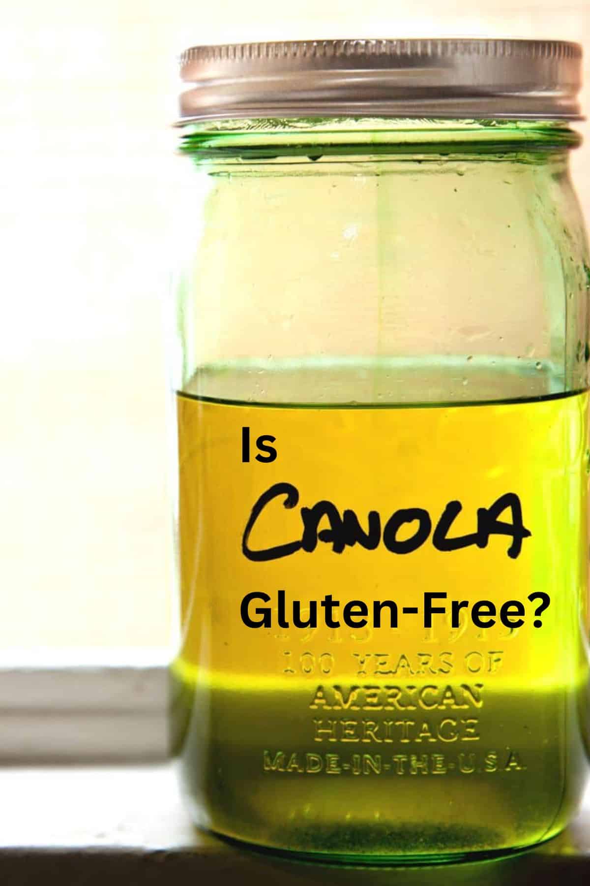 A jar of canola oil on a kitchen counter.