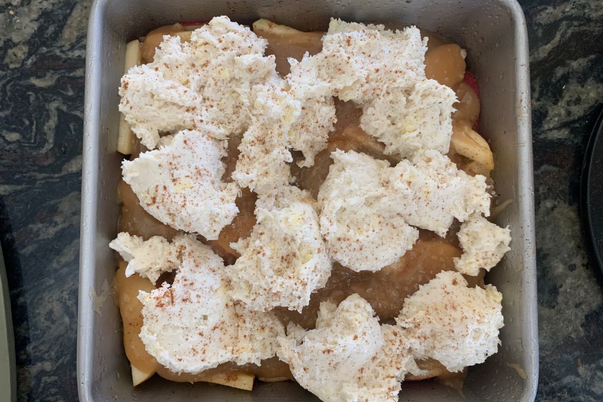 Apple cobbler in an 8x8 pan ready to bake.