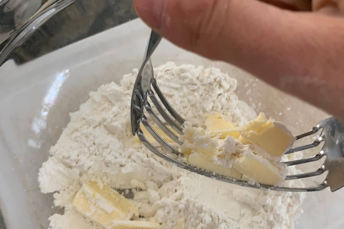 Using a pastry blender to cut in cold butter.