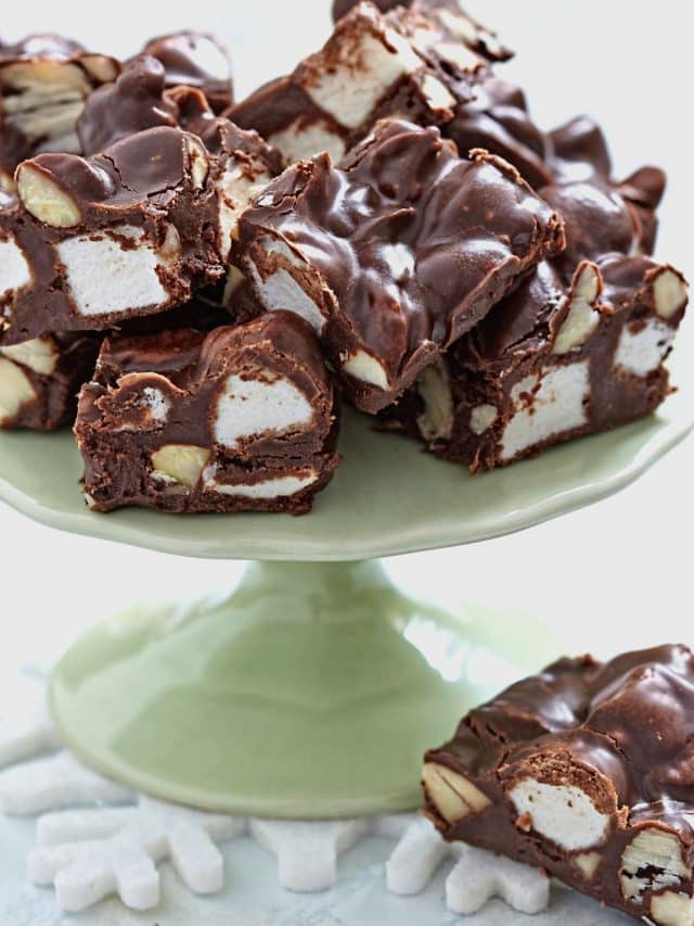 a pale green colored platter with fudge pieces on top.