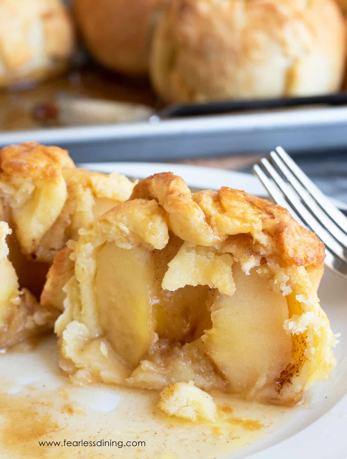 A close up view of a cut gluten free apple dumpling.