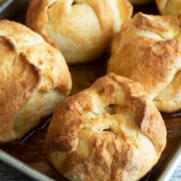 A baking dish full of baked apple dumplings.