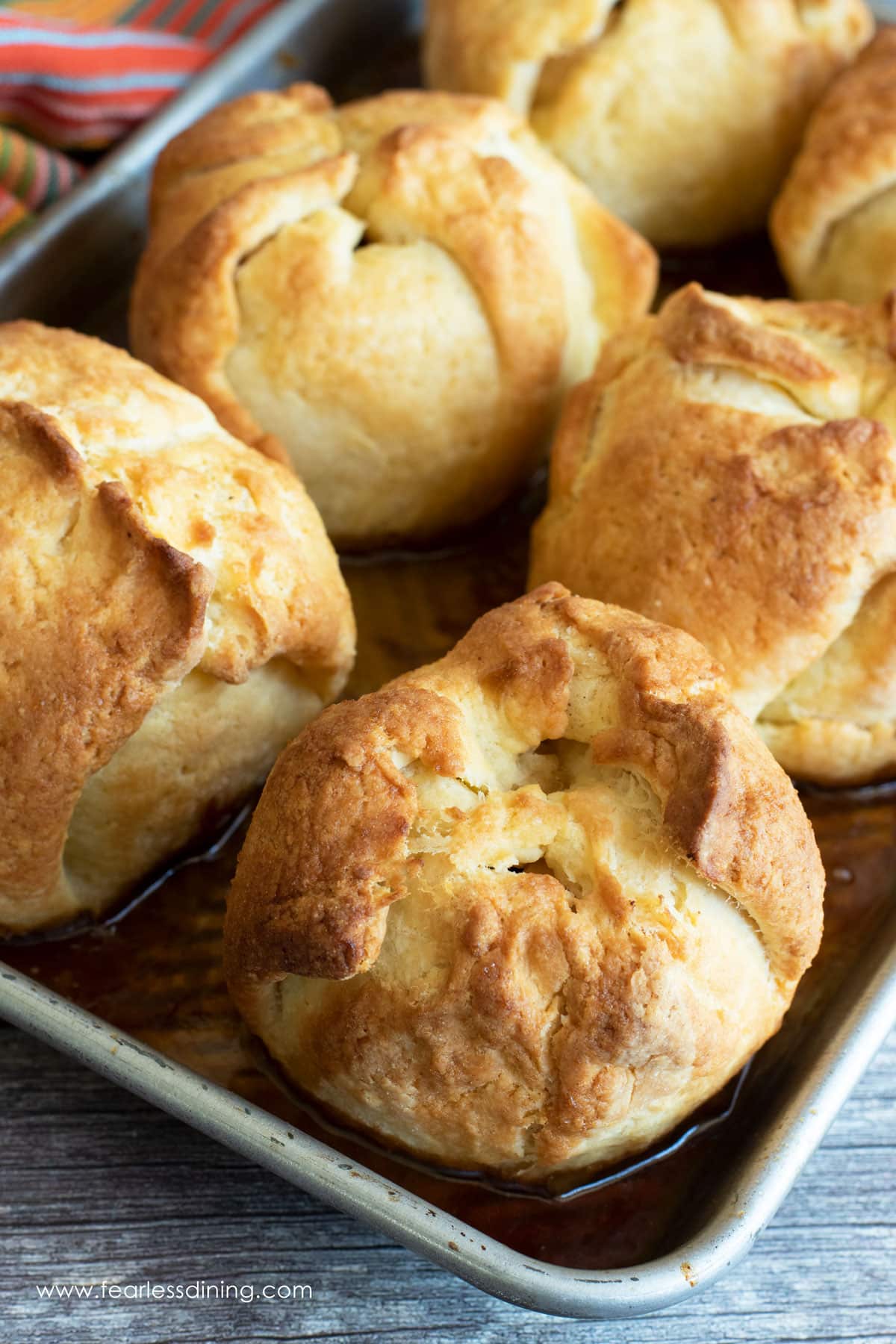 A baking dish full of baked apple dumplings.