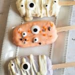 Halloween cakesicles on a plate.