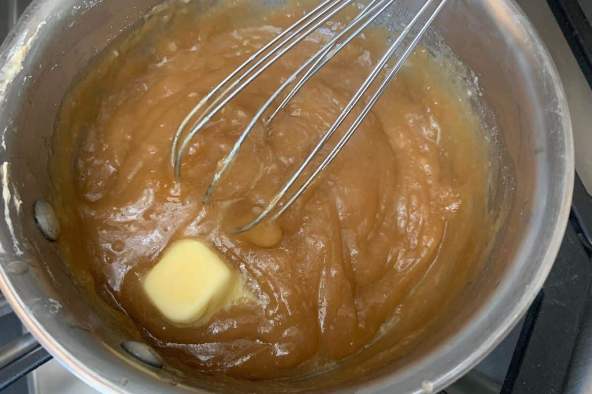 Whisking the caramel sauce in a pan.