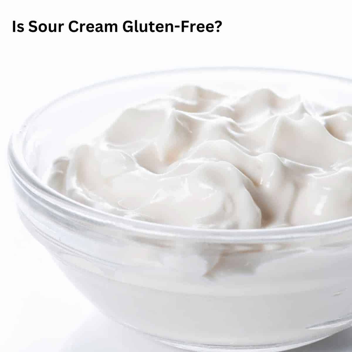 A glass bowl filled with sour cream.
