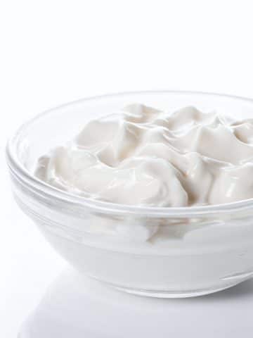 a small glass bowl of sour cream.